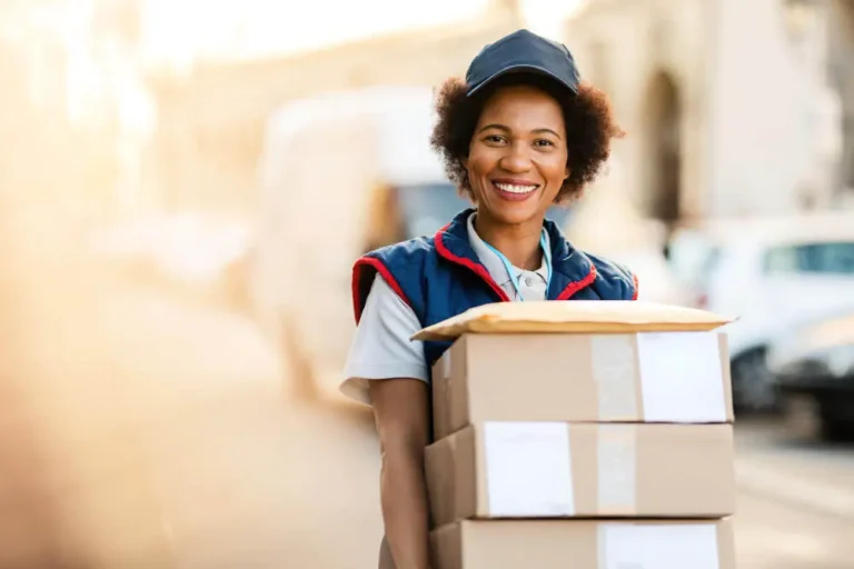portrait-happy-black-courier-delivering-packages-looking-camera_50